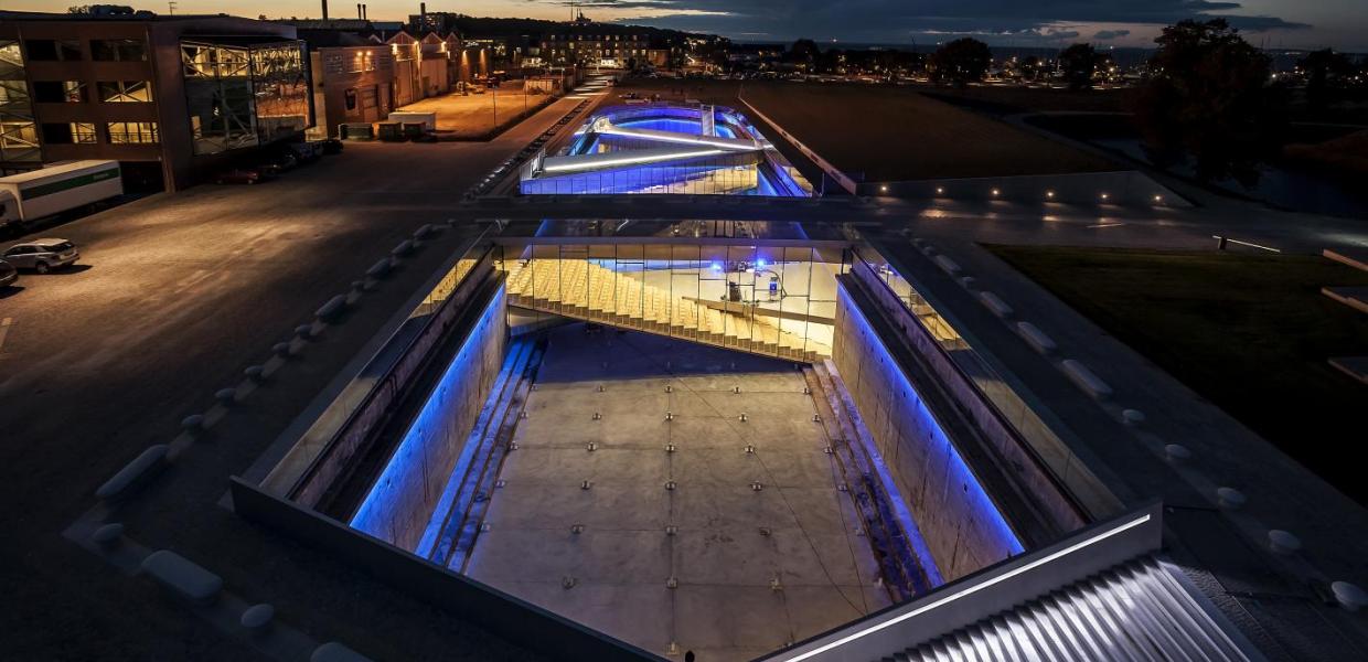 The Danish Maritime Museum in Helsingør, Denmark, lit up at night with neon lights