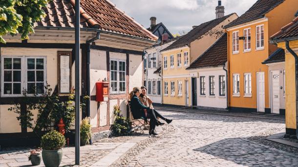 Women sitting on a bench in old town of Odense on Fyn