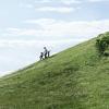 Family running of green hill North Zealand