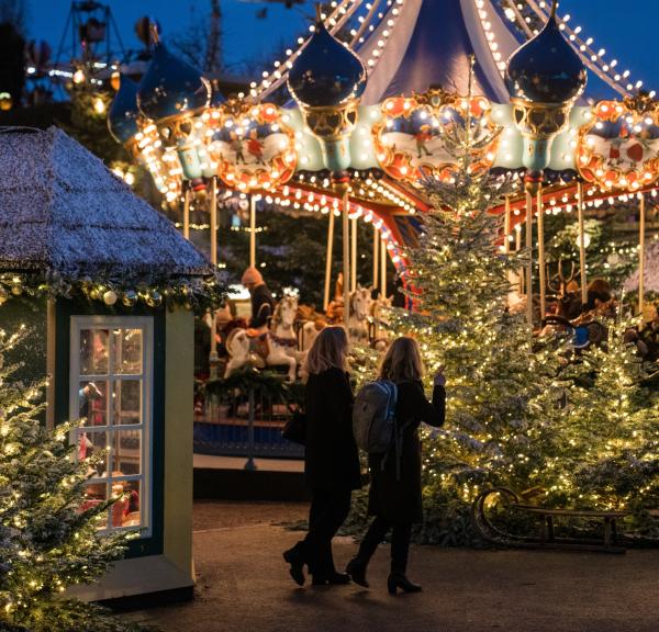 Julstämning på Tivoli. Bilden visar en gammeldags karusell med julgranar framför.