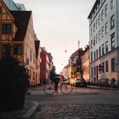 Girl biking in the neighbourhood of Christianshavn in Copenhagen