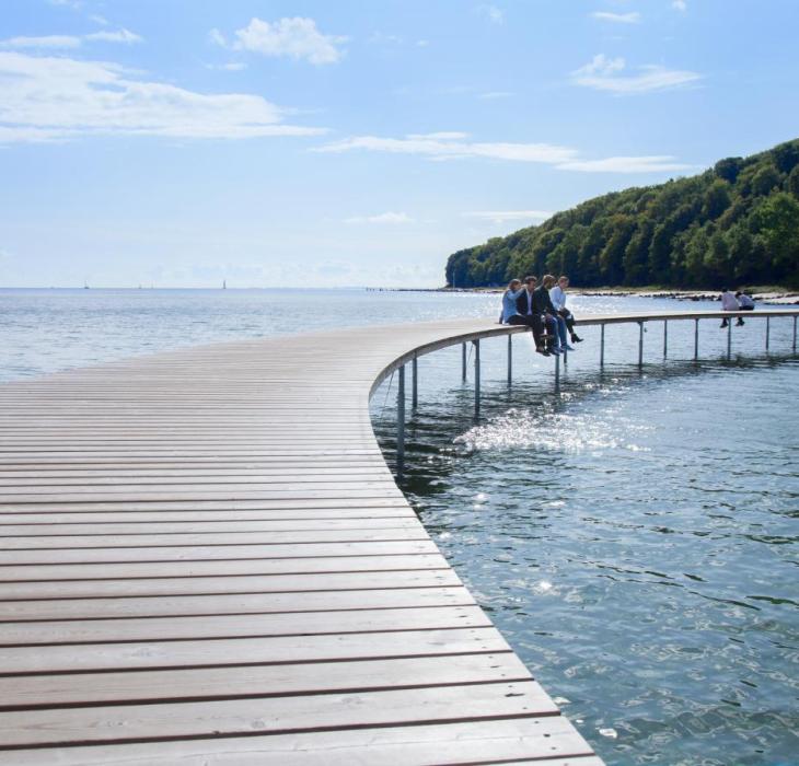 Business events delegates sitting on the Infinity bridge in Aarhus, Denmark